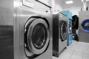 Industrial laundry washing machines in dry cleaner's workshop, PERC